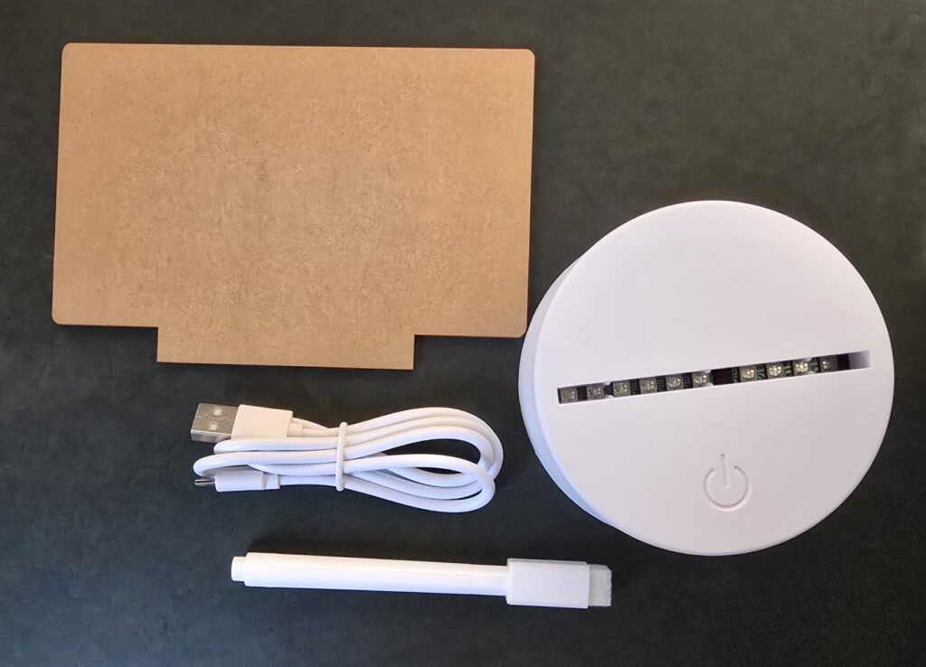Unboxed contents: Acrylic board, LED base, USB cable, and a white marker.